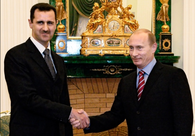 Vladimir Putin meets with Bashar Assad in Moscow's Kremlin.